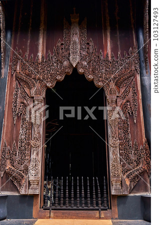 intricate details of the buildings' design and the contrast between their sharp edges and organic surroundings. 103127493