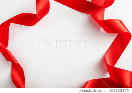 Red silk ribbon for wrapping gifts on white - Stock Photo