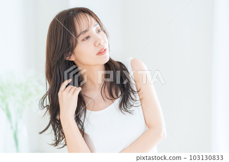 Young woman doing skin care in the living room Young woman doing skin care in the living room 103130833