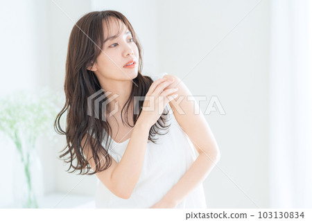 Young woman doing skin care in the living room 103130834