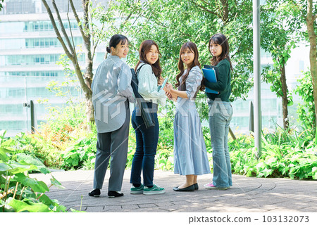 Four young women smiling outdoors Four young women smiling outdoors 103132073