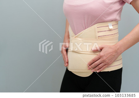 woman wearing lumbar support belts. pregnant and postnatal lumbar brace 103133685