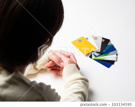 一個女人盯著大量信用卡的背影 一個女人盯著大量信用卡的背影 103134595