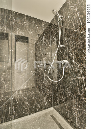 a modern bathroom with marble walls and flooring, including a walk - in shower head mounted on the wall a modern bathroom with marble walls and flooring, including a walk - in shower head mounted on the wall 103134933