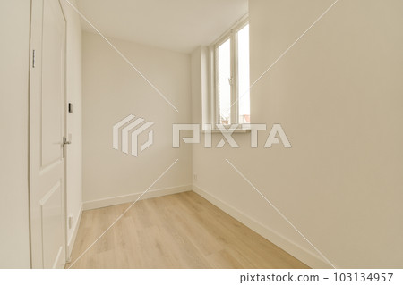 an empty room with white walls and wood flooring the door is open in front of the wall to the right an empty room with white walls and wood flooring the door is open in front of the wall to the right 103134957