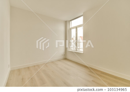 an empty room with white walls and wood flooring on the right, there is a window to the left an empty room with white walls and wood flooring on the right, there is a window to the left 103134965