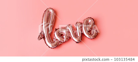 Love made from foil balloons on pink. Monochrome image. 103135484
