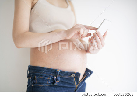 Pregnant woman using smartphone Pregnant woman using smartphone 103136263