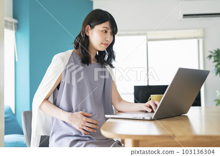 Pregnant woman doing remote work at home Pregnant woman doing remote work at home 103136304