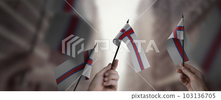 A group of people holding small flags of the Faroe Islands in their hands A group of people holding small flags of the Faroe Islands in their hands 103136705
