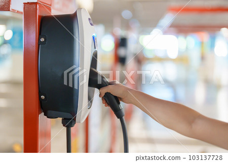 EV charger station for Electric car charging battery at station. green energy power, Eco friendly alternative, technology and environment concepts EV charger station for Electric car charging battery at station. green energy power, Eco friendly alternative, technology and environment concepts 103137728