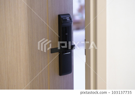 smart digital door lock while open or close the door at home or apartment. NFC Technology, Fingerprint scan, keycard, PIN number, smartphone, electrical and contactless lifestyle concepts smart digital door lock while open or close the door at home or apartment. NFC Technology, Fingerprint scan, keycard, PIN number, smartphone, electrical and contactless lifestyle concepts 103137735