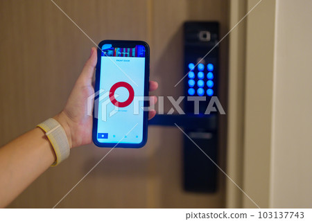 Hand using smartphone for close digital door lock at home or apartment. NFC Technology, Fingerprint scan, keycard, PIN number, smartphone, electrical and contactless lifestyle concepts 103137743