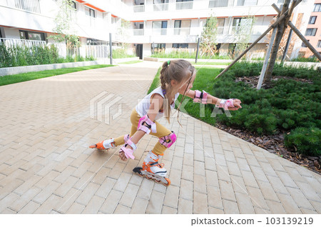 A little girl and her mom do a bridge exercise at the outdoor sports ground.  103139219