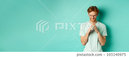 Devious redhead man in glasses and t-shirt pitching an idea, steeple fingers and look from under forehead with sly and smug smile, standing over mint background Devious redhead man in glasses and t-shirt pitching an idea, steeple fingers and look from under forehead with sly and smug smile, standing over mint background 103140975