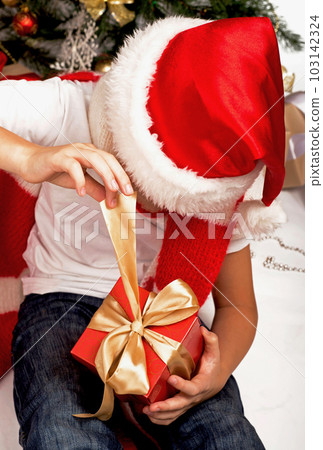 Christmas Kids. Happy Children Opening Gifts. new year. Boy receiving Christmas gifts Christmas Kids. Happy Children Opening Gifts. new year. Boy receiving Christmas gifts 103142324