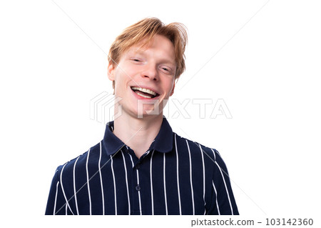 portrait of a well-groomed handsome European 25s blond man in a blue polo portrait of a well-groomed handsome European 25s blond man in a blue polo 103142360