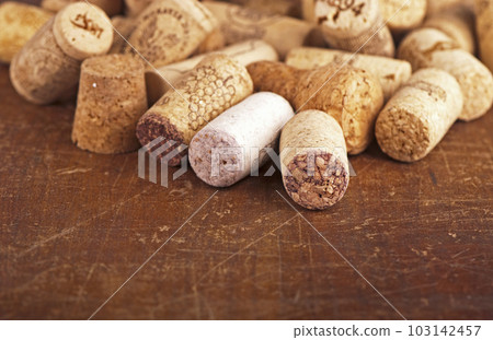 Old Dated wine bottle corks on the wooden background. Close up Vintage background with empty space for text 103142457