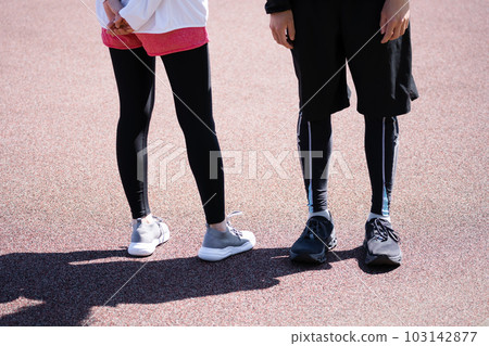 Feet of a young couple running in the park Feet of a young couple running in the park 103142877
