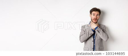 Distressed young man in business suit strangle himself and showing tongue, feeling sick with sore throat, standing on white background Distressed young man in business suit strangle himself and showing tongue, feeling sick with sore throat, standing on white background 103144695