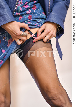 Closeup view of a woman fixing garter belt 103147270