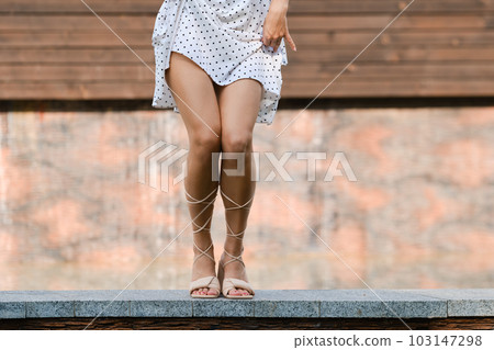 Cute woman dancing outdoor, squatting legs Cute woman dancing outdoor, squatting legs 103147298