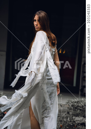a young girl in a white dress dancing, sewn with her own hands, slow movement and singing outdoors in a religious park, street, having fun alone, emotionally a young girl in a white dress dancing, sewn with her own hands, slow movement and singing outdoors in a religious park, street, having fun alone, emotionally 103148383