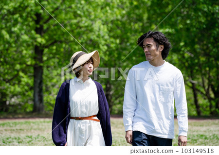 young couple walking in the park 103149518