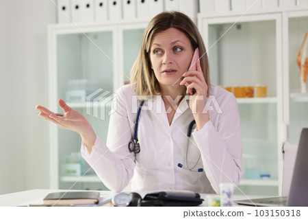 Doctor talks to patient on phone listening to complaints 103150318