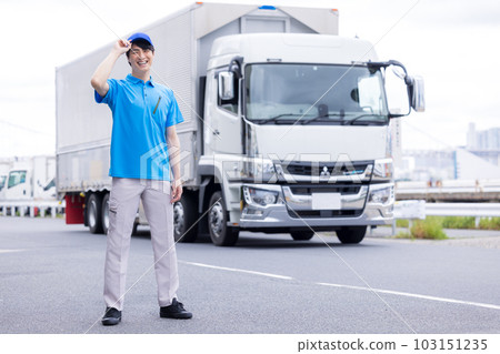 Driver smiling and standing in front of truck 103151235