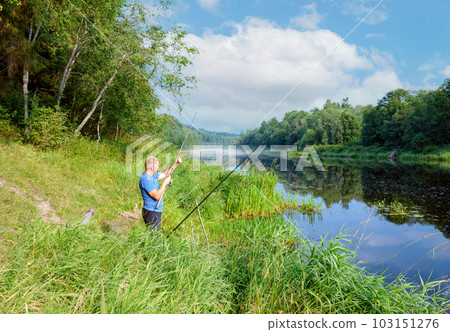 In the early summer morning, a fisherman is fishing in the upper reaches of the Volga River. In the early summer morning, a fisherman is fishing in the upper reaches of the Volga River. 103151276