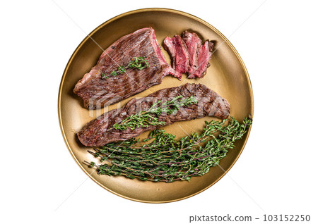 BBQ grilled Bavette Bavet beef meat steak with herbs on a plate. Isolated on white background. BBQ grilled Bavette Bavet beef meat steak with herbs on a plate. Isolated on white background. 103152250