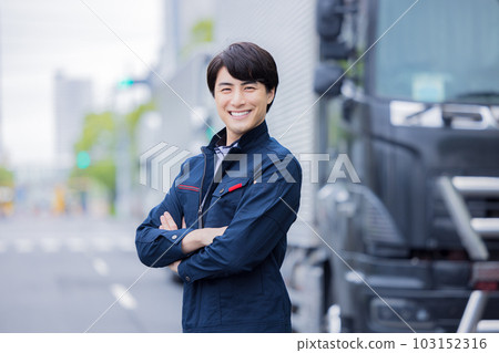 Driver smiling and standing in front of truck Driver smiling and standing in front of truck 103152316