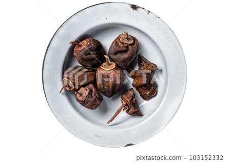 Natural Sun Dried persimmon fruit on a plate. Isolated on white background. 103152332
