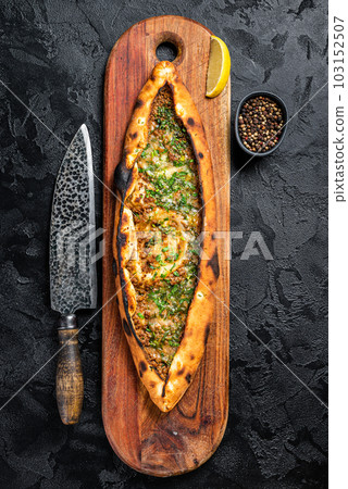 Turkish pide pie with beef meat and vegetables. Black background. Top view Turkish pide pie with beef meat and vegetables. Black background. Top view 103152507