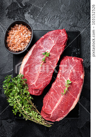 Raw wagyu oyster top blade steaks, organic beef meat. Black background. Top View Raw wagyu oyster top blade steaks, organic beef meat. Black background. Top View 103152526