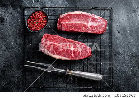Raw top blade cut organic beef meat. Black background. Top View 103152563