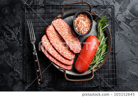Turkish Sliced Sucuk beef meat sausage ready for cooking. Black background. Top view Turkish Sliced Sucuk beef meat sausage ready for cooking. Black background. Top view 103152645