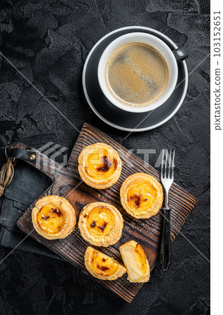 Custard Tarts Pasteis de Belem, Portuguese pastel de Nata. Black background. Top view Custard Tarts Pasteis de Belem, Portuguese pastel de Nata. Black background. Top view 103152651