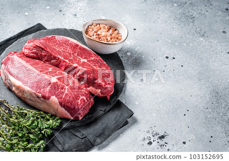 Raw top blade flat Iron beef organic meat. Gray background. Top View. Copy space 103152695