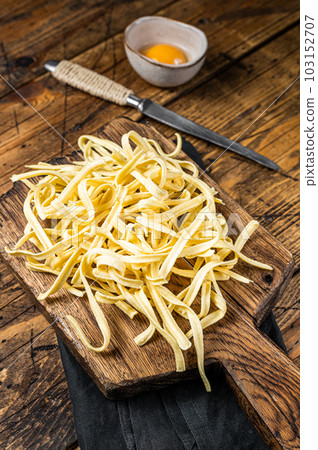 Cooking raw spaetzle egg noodle. Wooden background. Top view Cooking raw spaetzle egg noodle. Wooden background. Top view 103152707