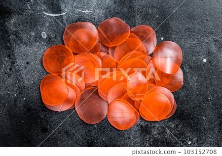 Raw kerupuk or prawn shrimp crackers, chips. Black background. Top view 103152708