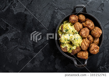 Skillet with Swedish beef Meatballs with Cream Sauce. Black background. Top view. Copy space 103152741