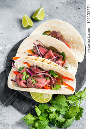 Homemade Mexican Steak Steet Tacos with Cilantro, green sauce, jalapenos and onion. Gray background. top view 103152774