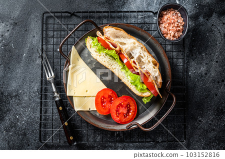 Deli meat sandwich with turkey ham, cheese, tomato and Lettuce. Black background. Top view 103152816