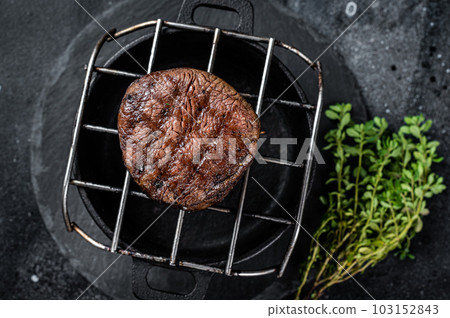Fillet Mignon grilled beef Steak on a grill. Black background. Top view 103152843
