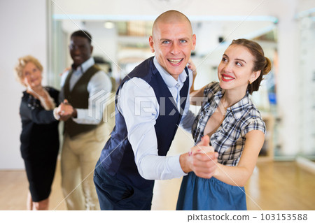 Man and woman performing ballroom dance in dancing room Man and woman performing ballroom dance in dancing room 103153588