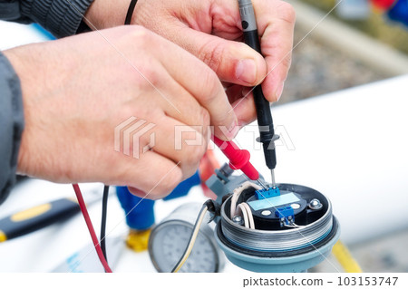 Checking gas equipment sensor with multimeter. Close-up hands. Diagnostics of industrial equipment. 103153747