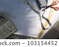 fashion designer tools in the fashion business. The dressmaker's workplace. A designer's desktop with sewing tools, a pattern on paper.Tailoring business. Banner 103154452