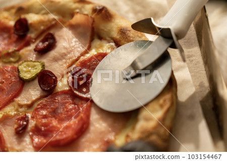 Juicy, fragrant delicious pizza on the table on a sunny day 103154467